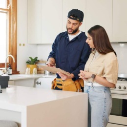 Find your perfect fit at Folio a man in a kitchen holding a clipboard next to a woman