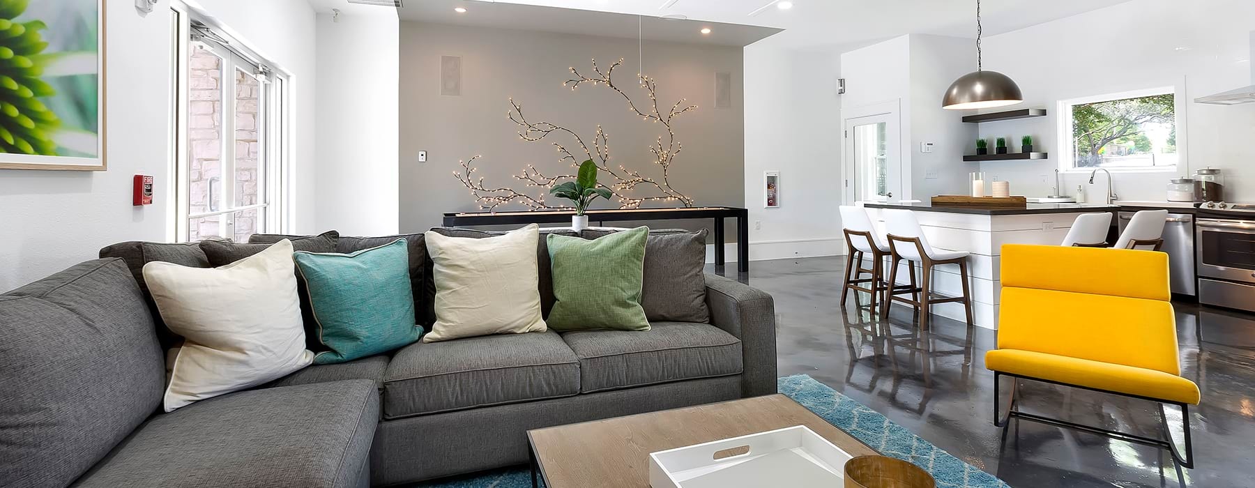 a clubroom with a couch, tables and chairs