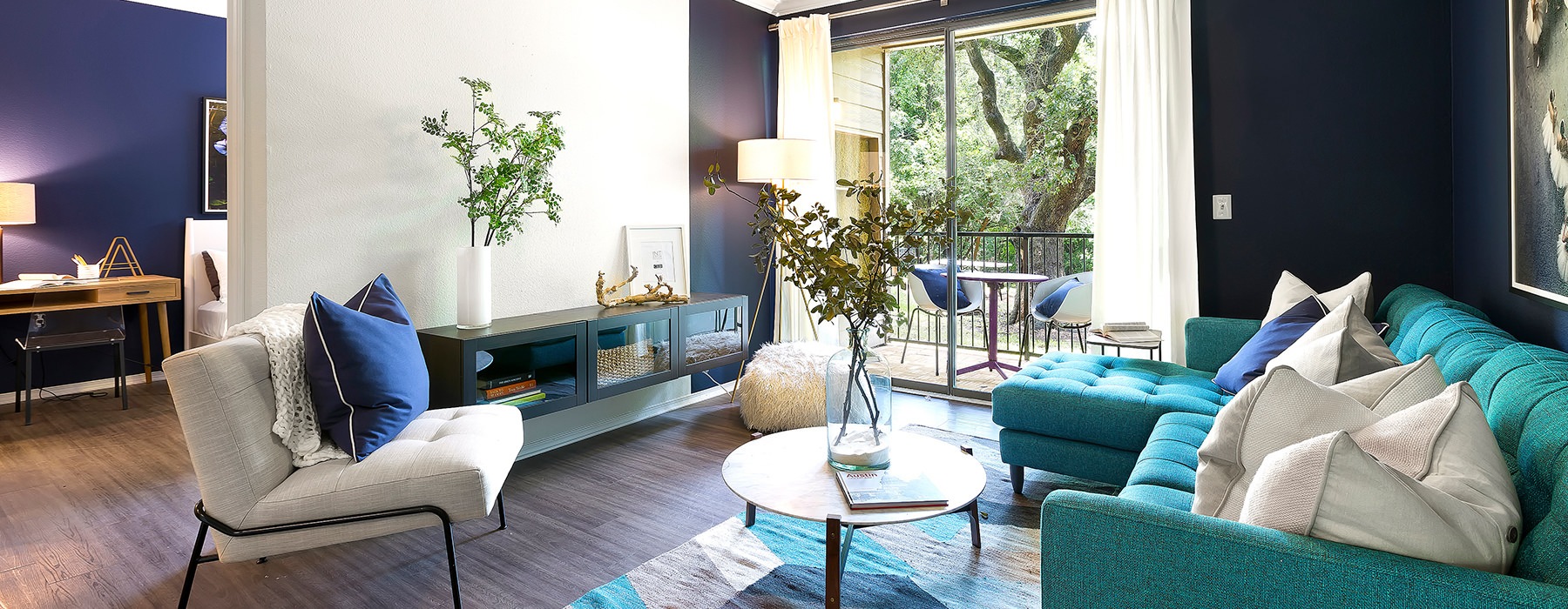 Living room with bright colored sofa at Folio apartments in North Austin, TX